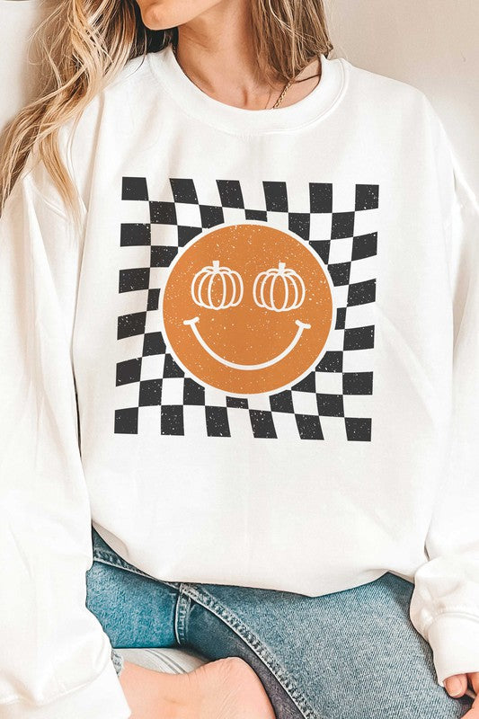 Sweat-shirt à carreaux avec visage souriant et citrouille