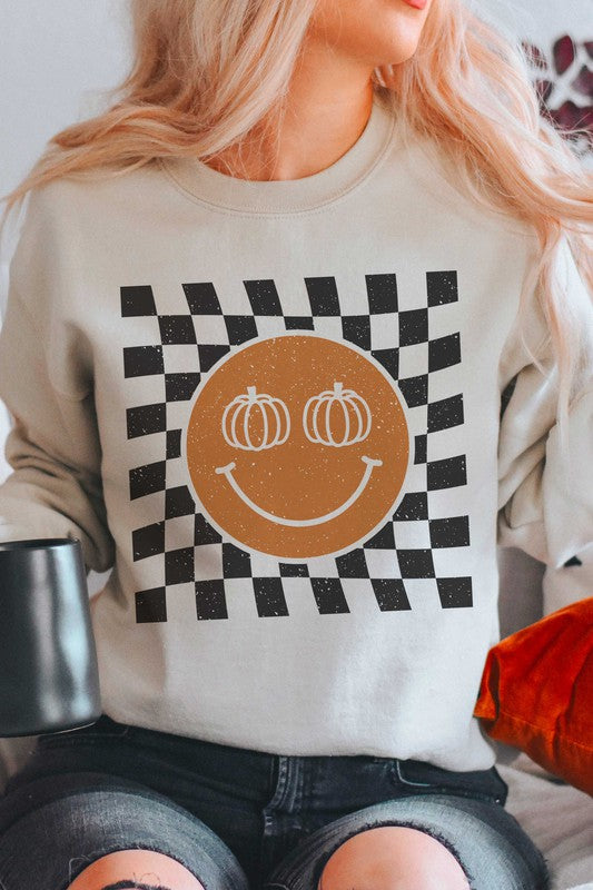 Sweat-shirt à carreaux avec visage souriant et citrouille